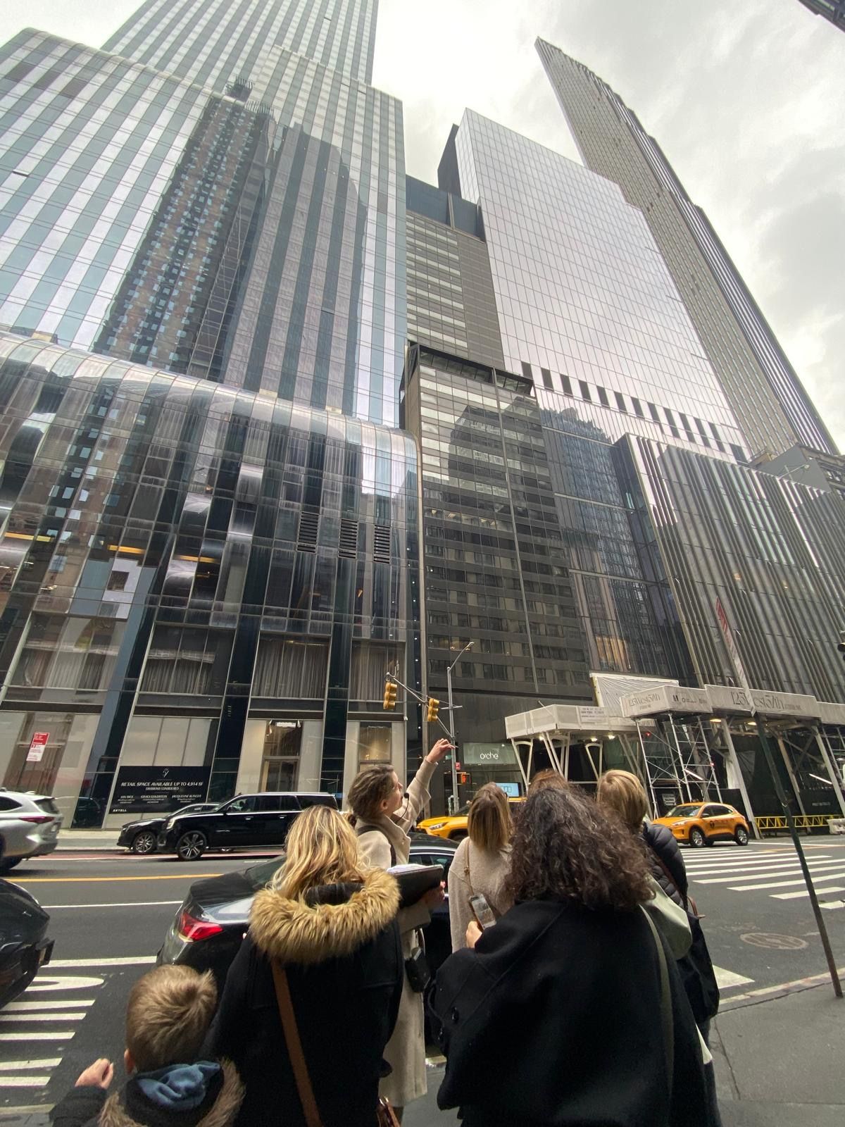 Guide montrant les buildings de New York à un groupe de touristes