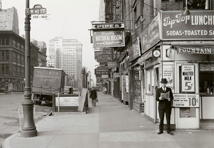 A man reads a newspaper on New York's 6th Ave. and 40th S on May 18, 1940